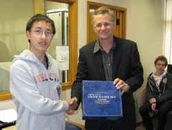 Stephen Xie being presented with a copy of the game by Frank Newman.